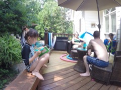 Everyone relaxing in the pool, the deck and in a book